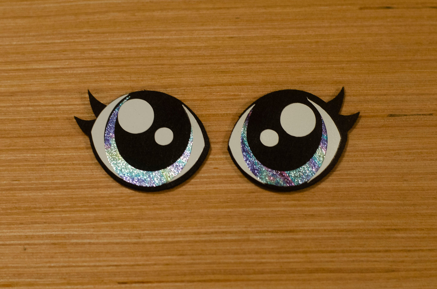 a couple of black and white buttons on a wooden surface
