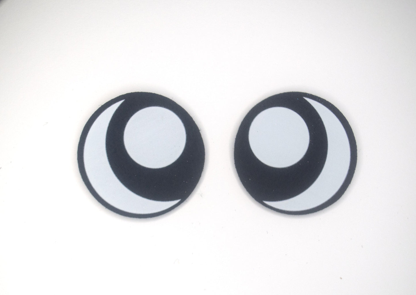 a pair of black and white circles on a white surface