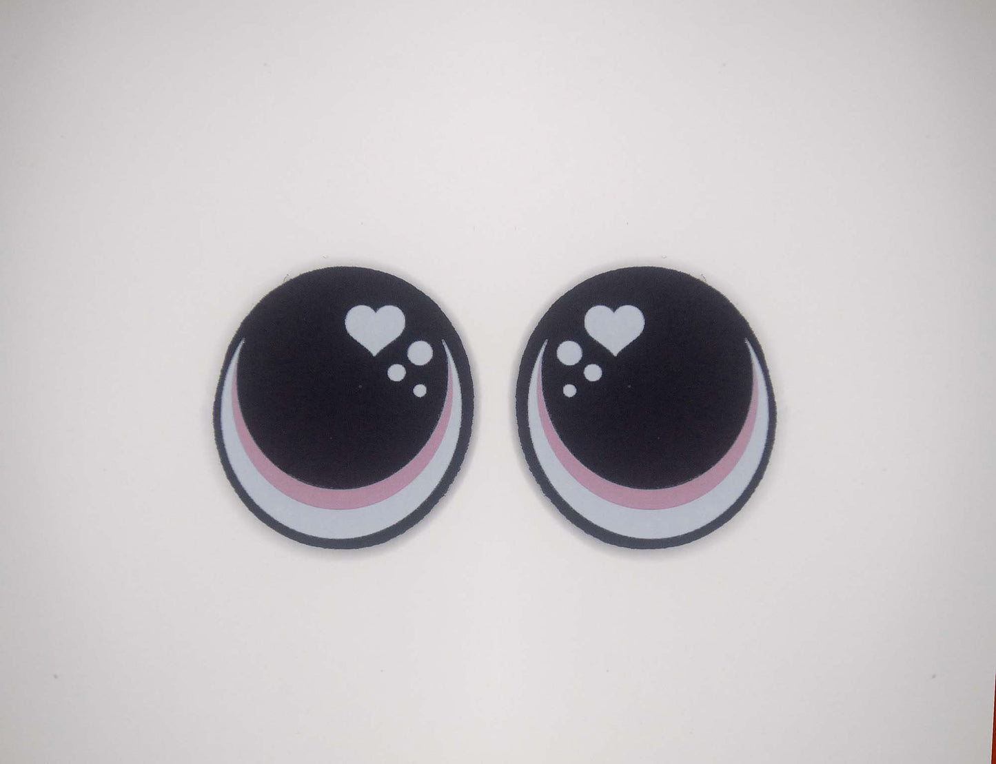 two black and white buttons with hearts on them