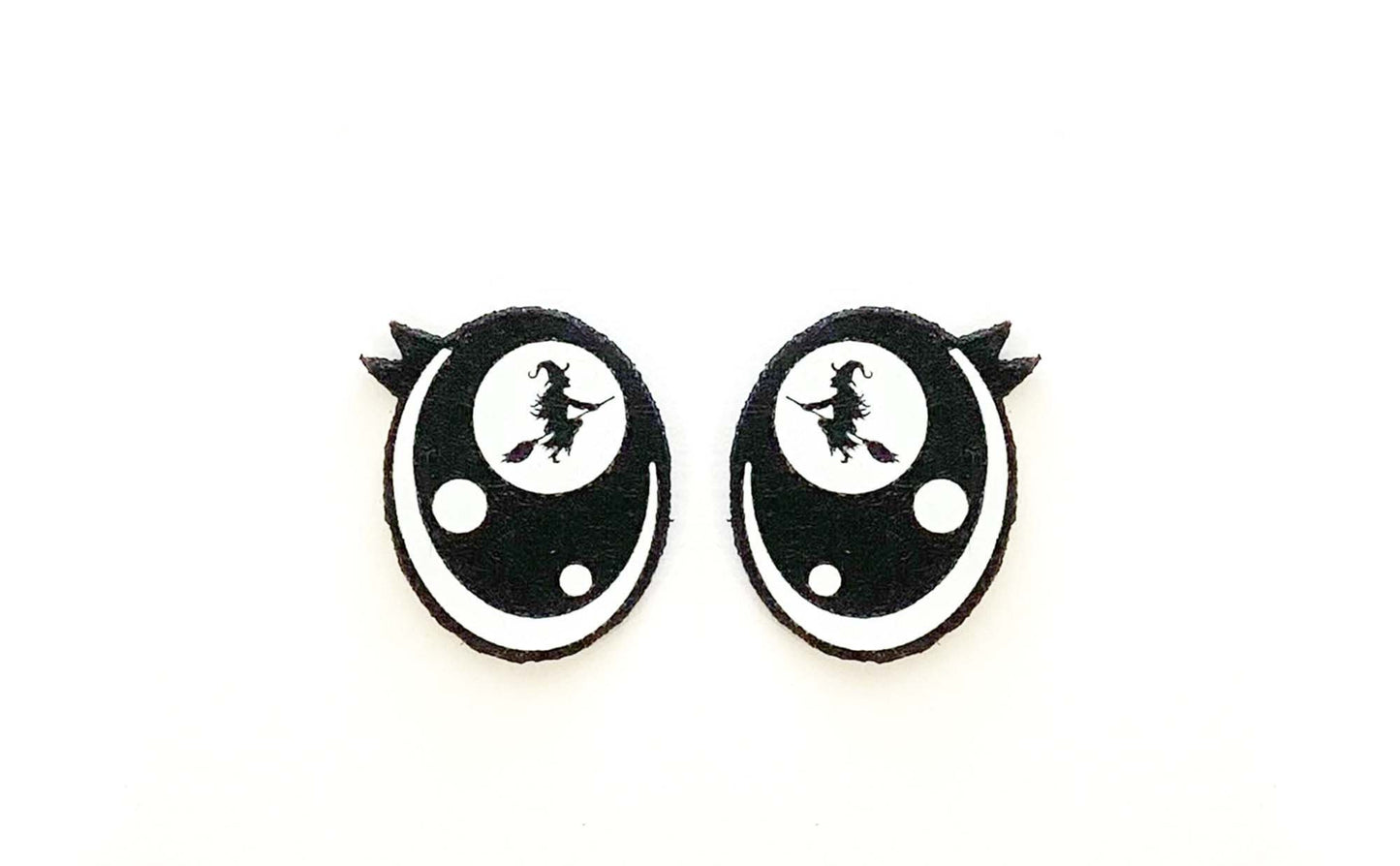 a pair of black and white earrings on a white background