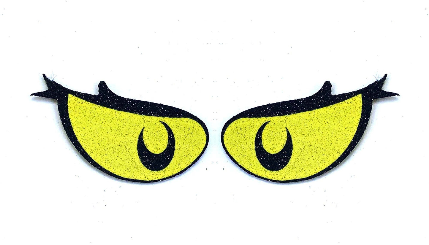 a pair of yellow eyes with black eyelashes