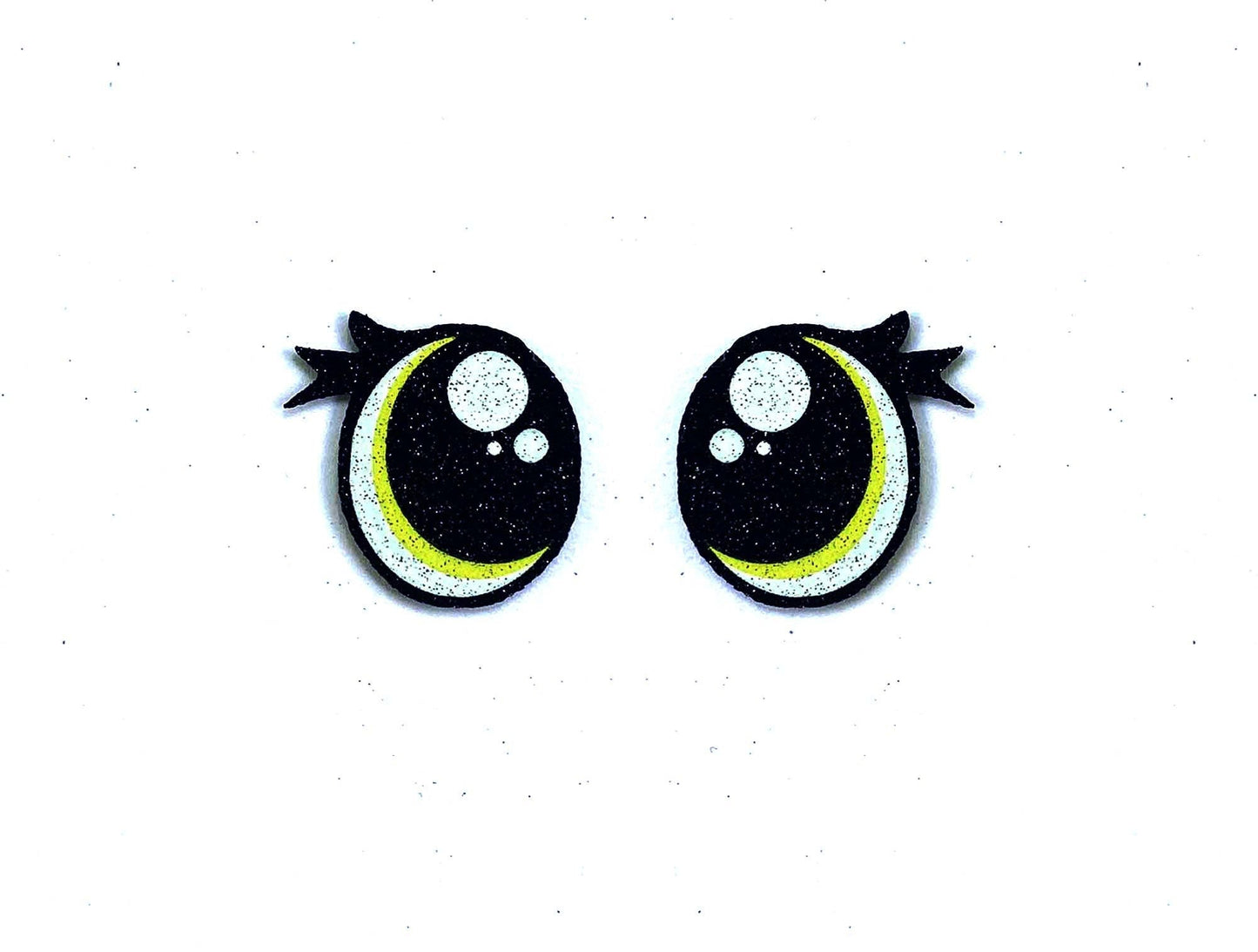 a pair of black and yellow eyes with black bows