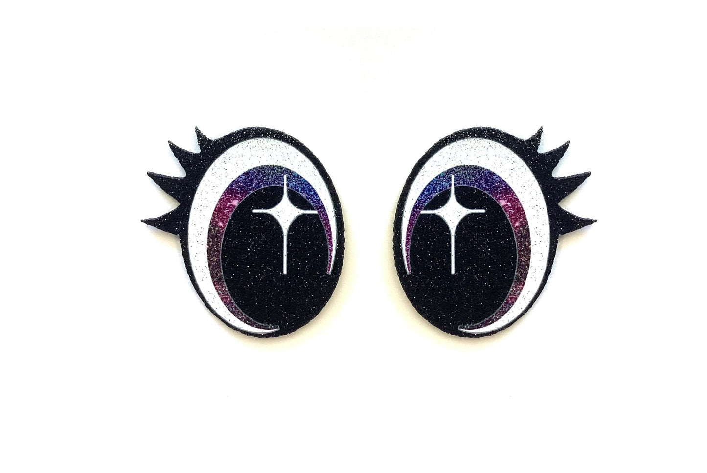 a pair of black and white earrings with spikes