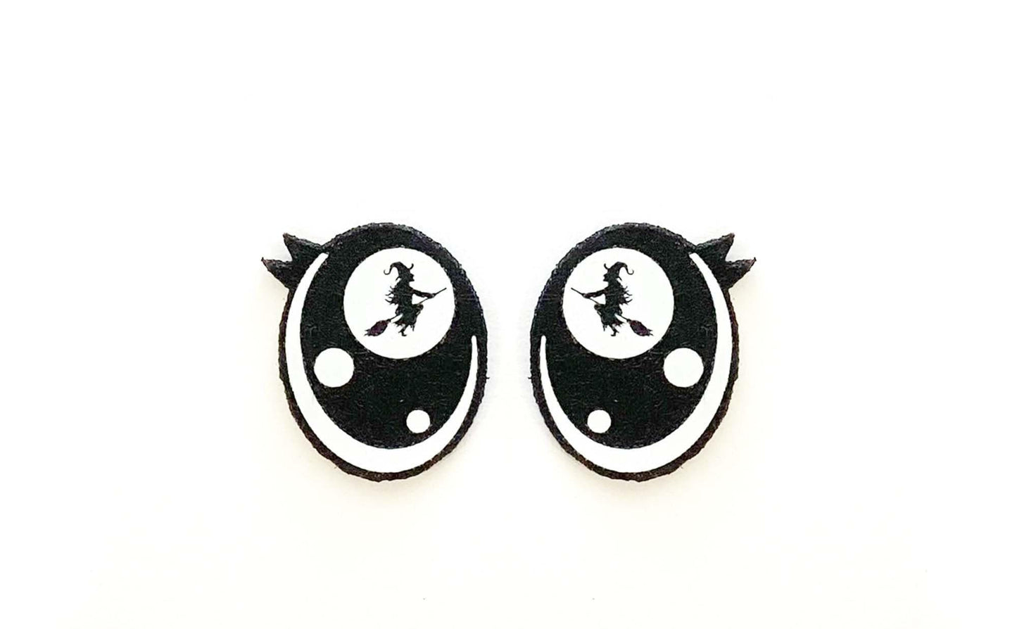 a pair of black and white earrings on a white background