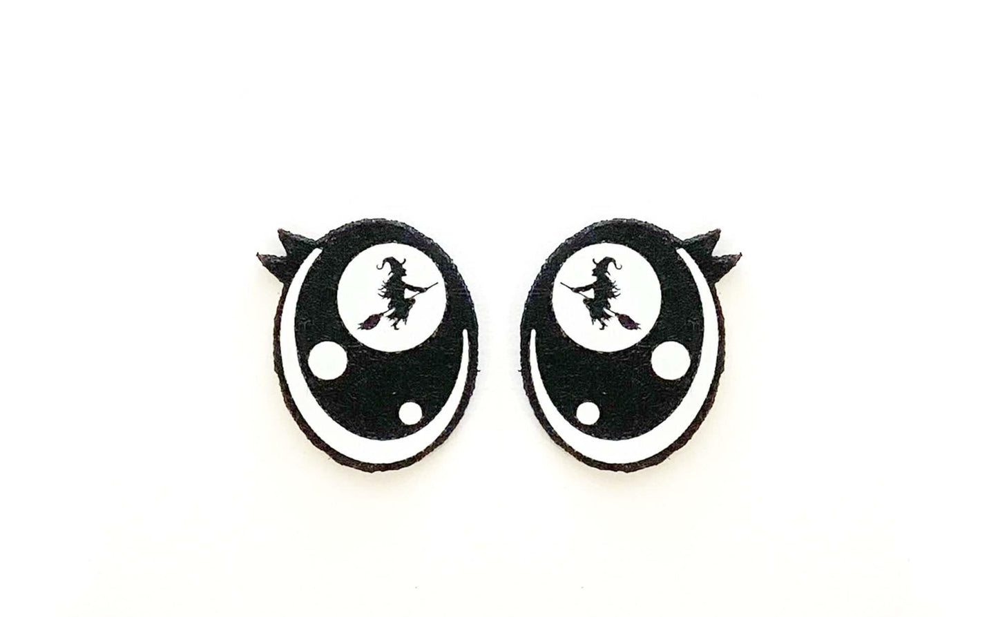 a pair of black and white earrings on a white background