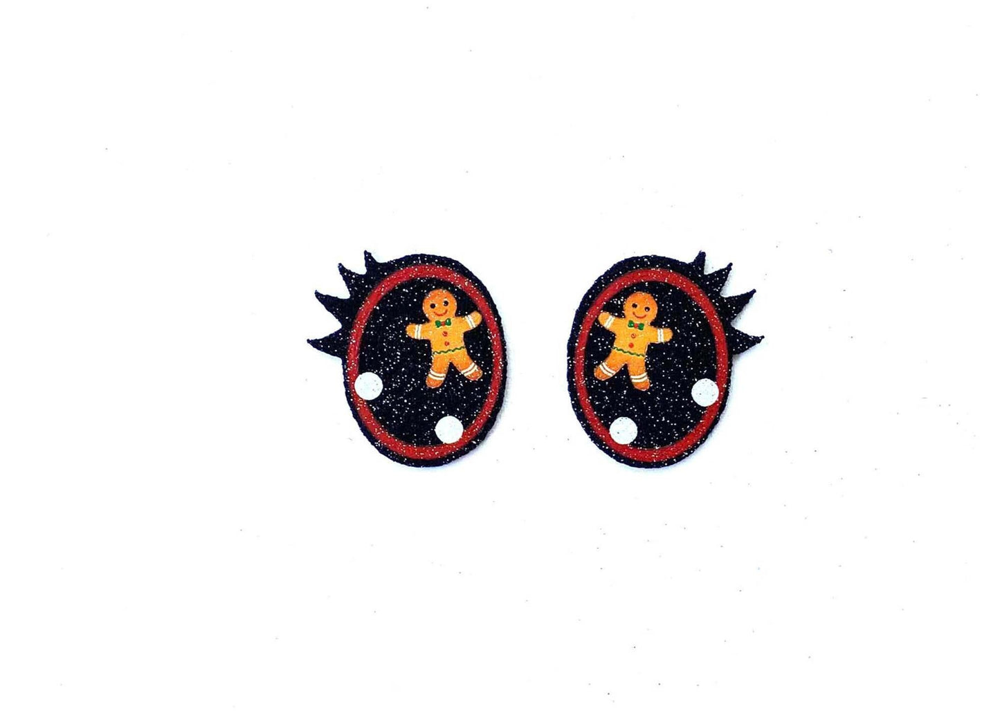 a pair of black and red buttons with a picture of a teddy bear