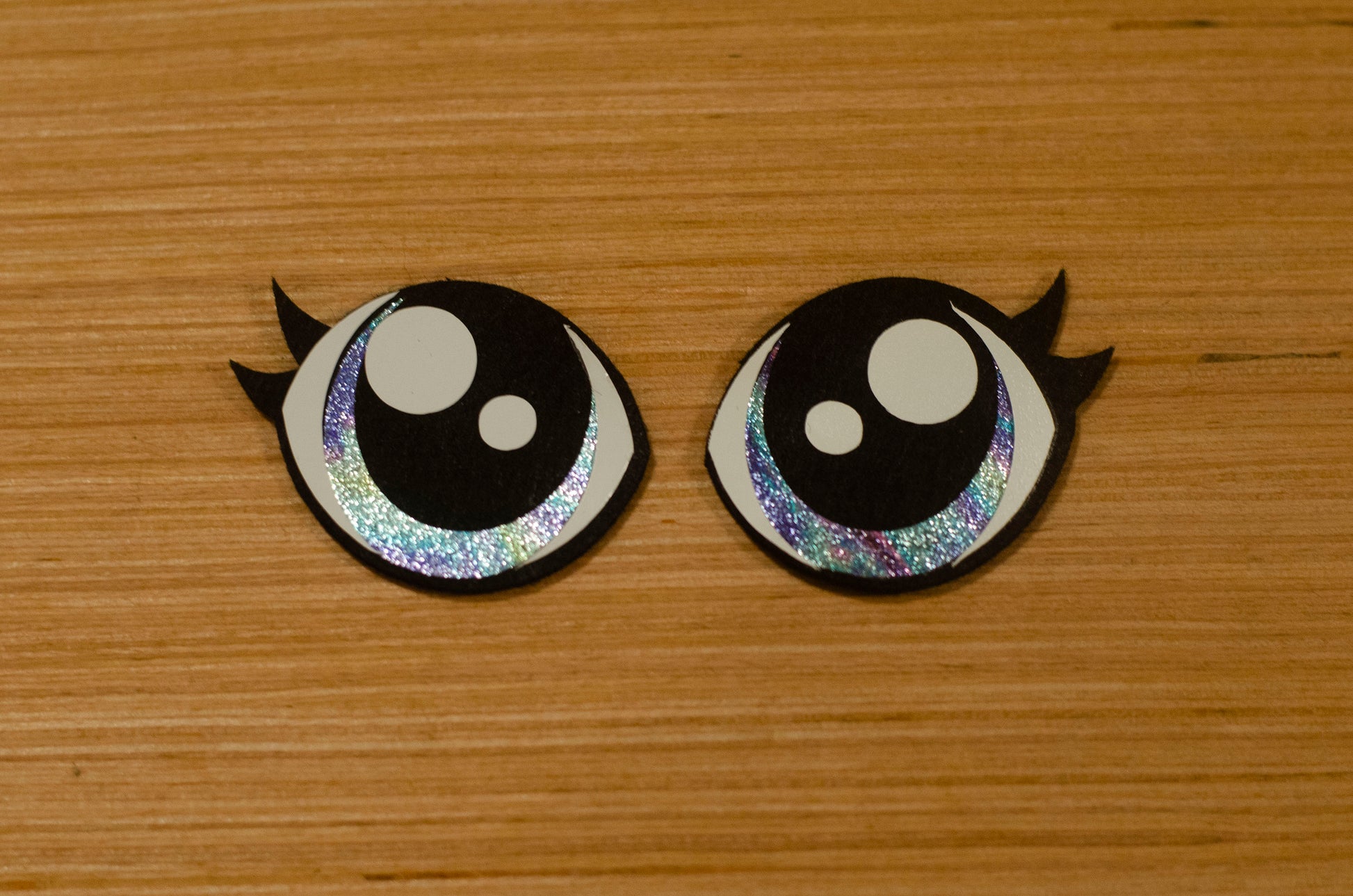 a couple of black and white buttons on a wooden surface