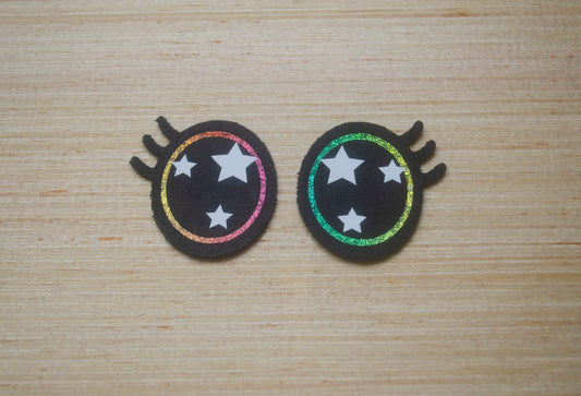 a pair of hair clips with stars on them