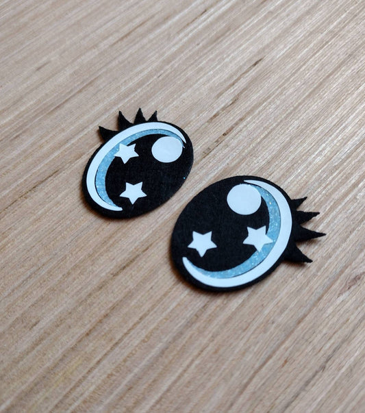 a pair of black and white stars and moon buttons