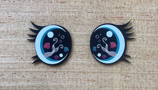 a pair of black and blue mermaid felt eyes