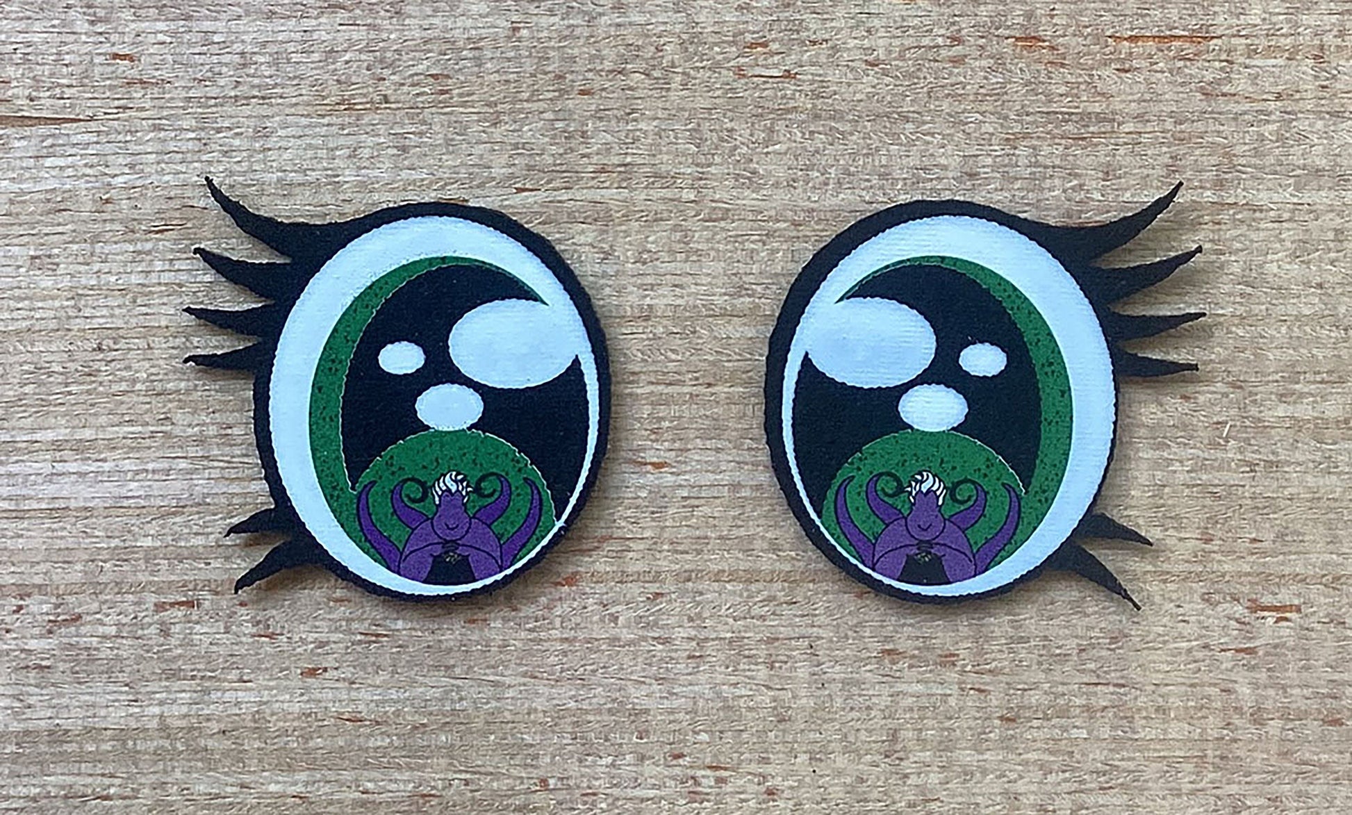 two black and white patches with green and purple designs