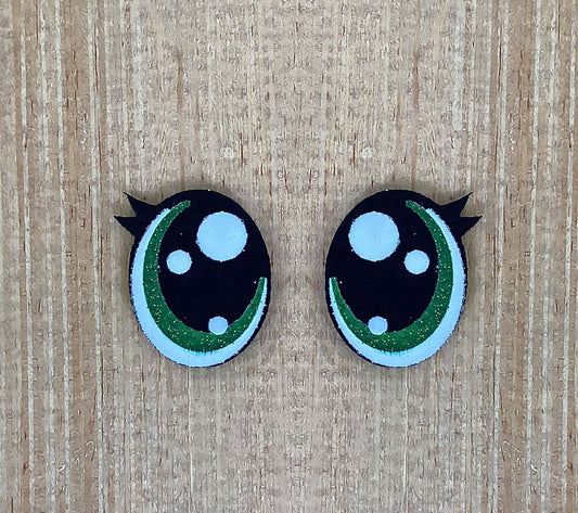 a pair of black and green buttons with white dots