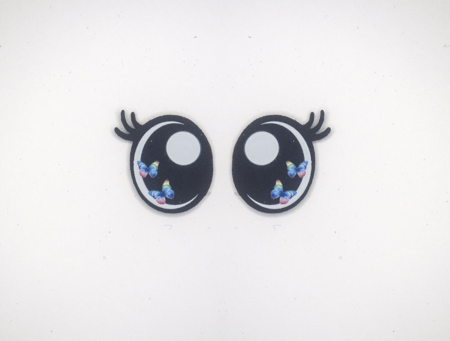 a pair of black and white eyes with blue flowers