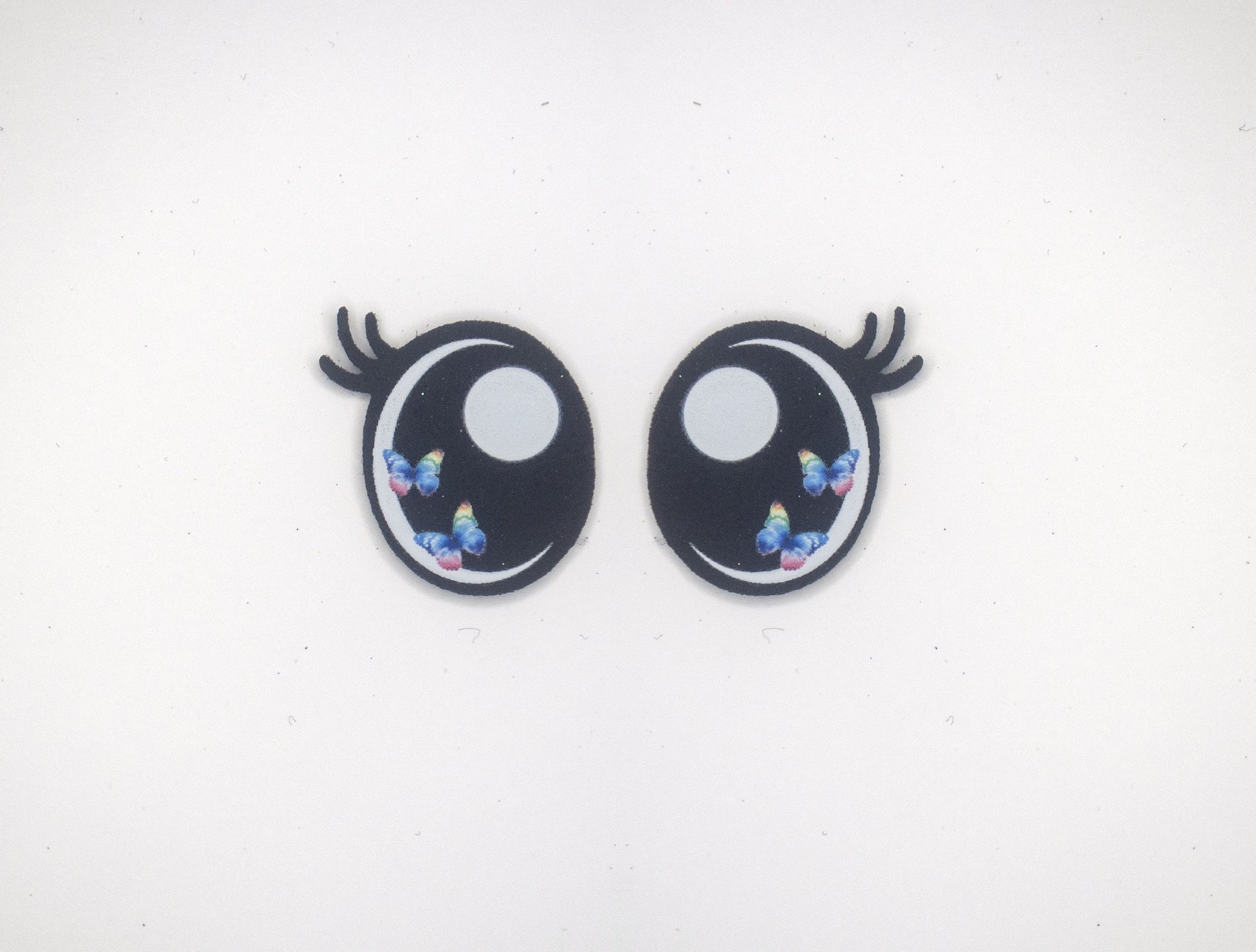 a pair of black and white eyes with blue flowers