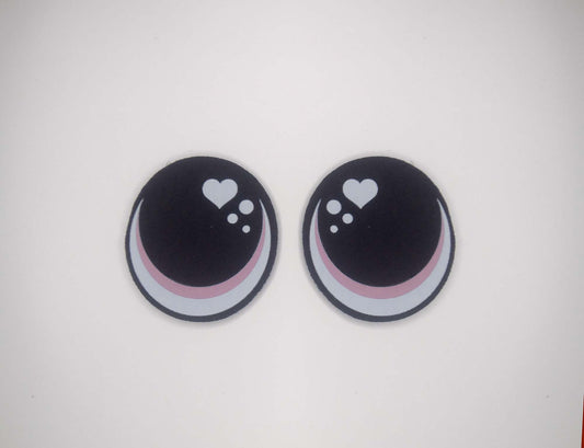 two black and white buttons with hearts on them