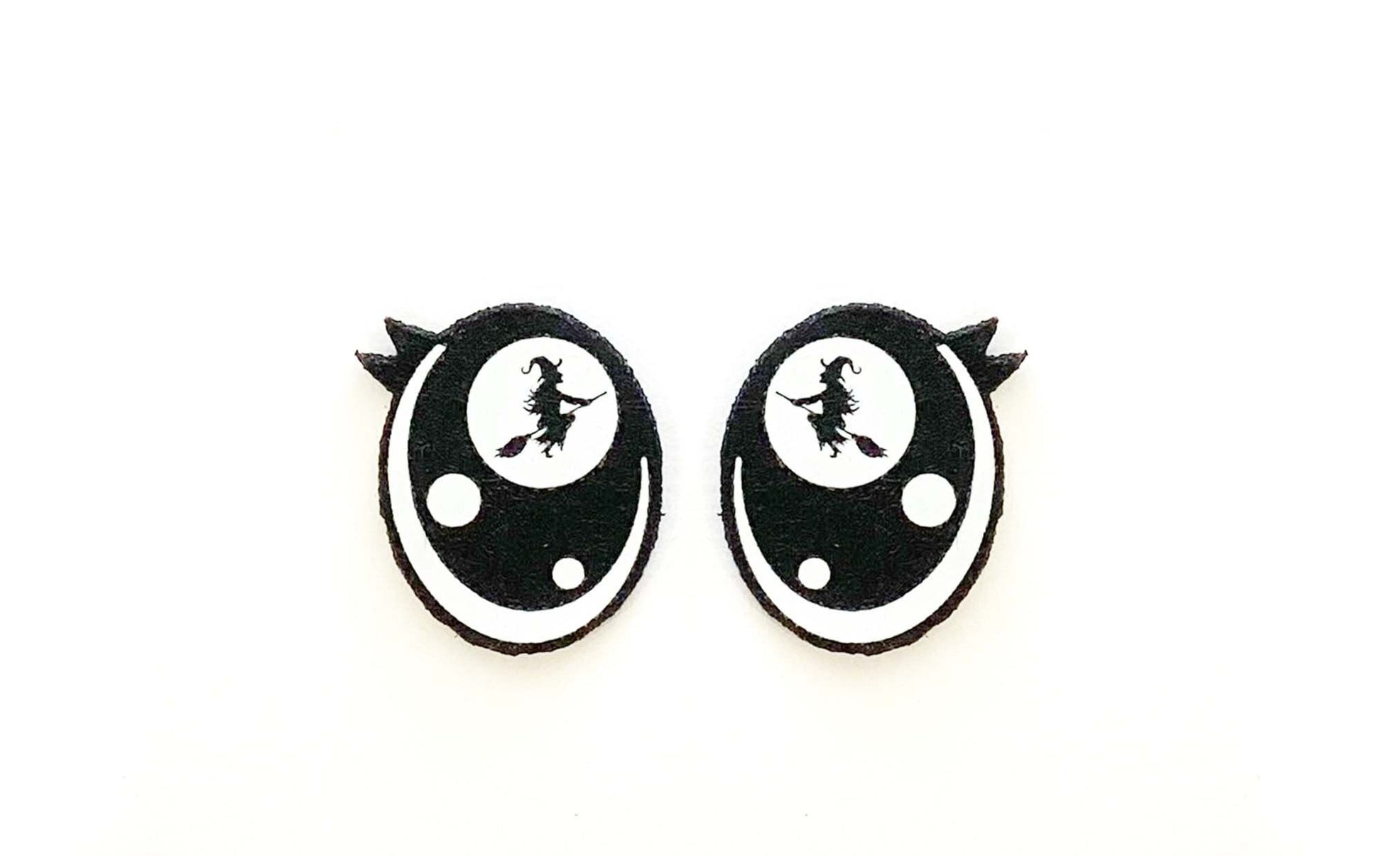 a pair of black and white earrings on a white background