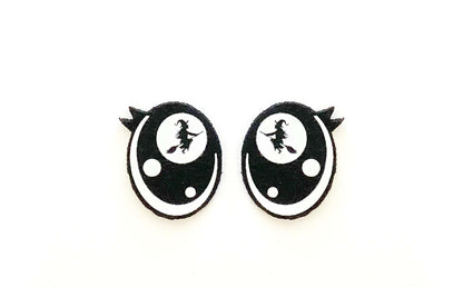 a pair of black and white earrings on a white background
