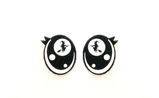 a pair of black and white earrings on a white background