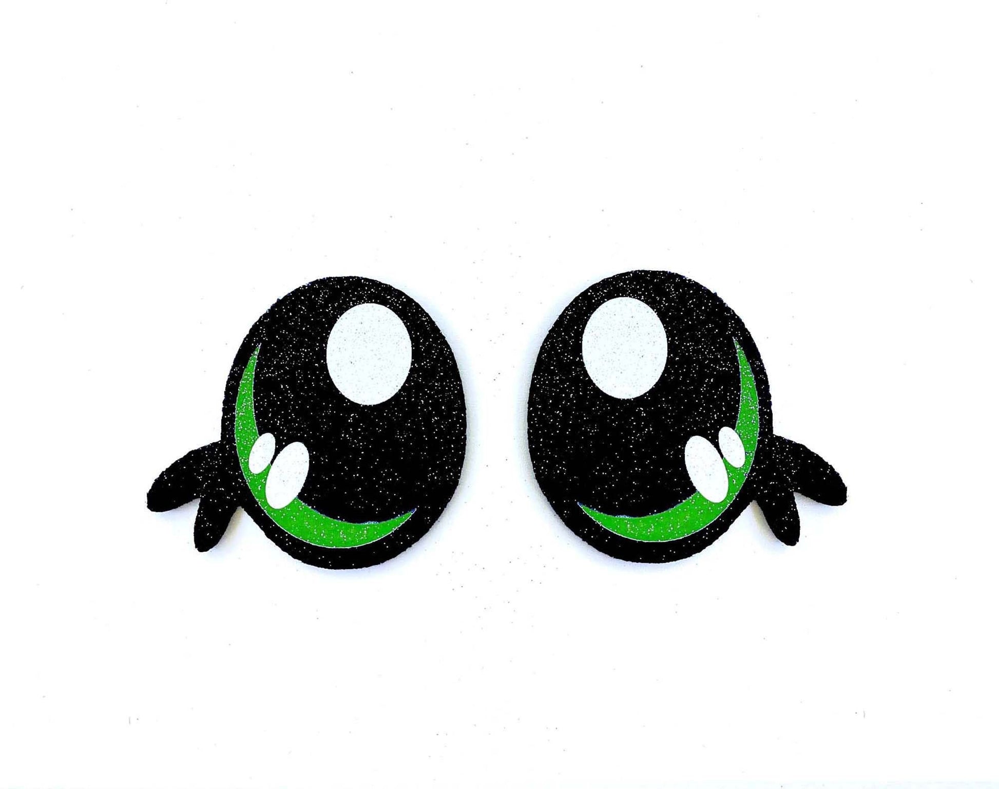 a pair of black and green eyes on a white background