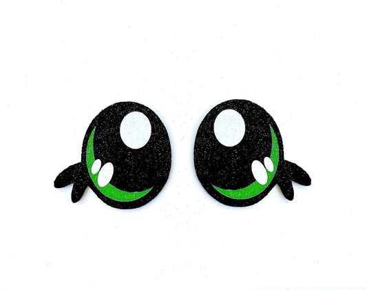 a pair of black and green eyes on a white background