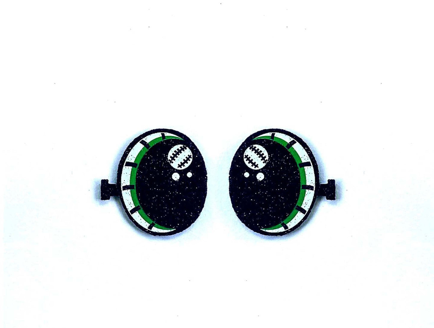 a pair of black and green buttons on a white background