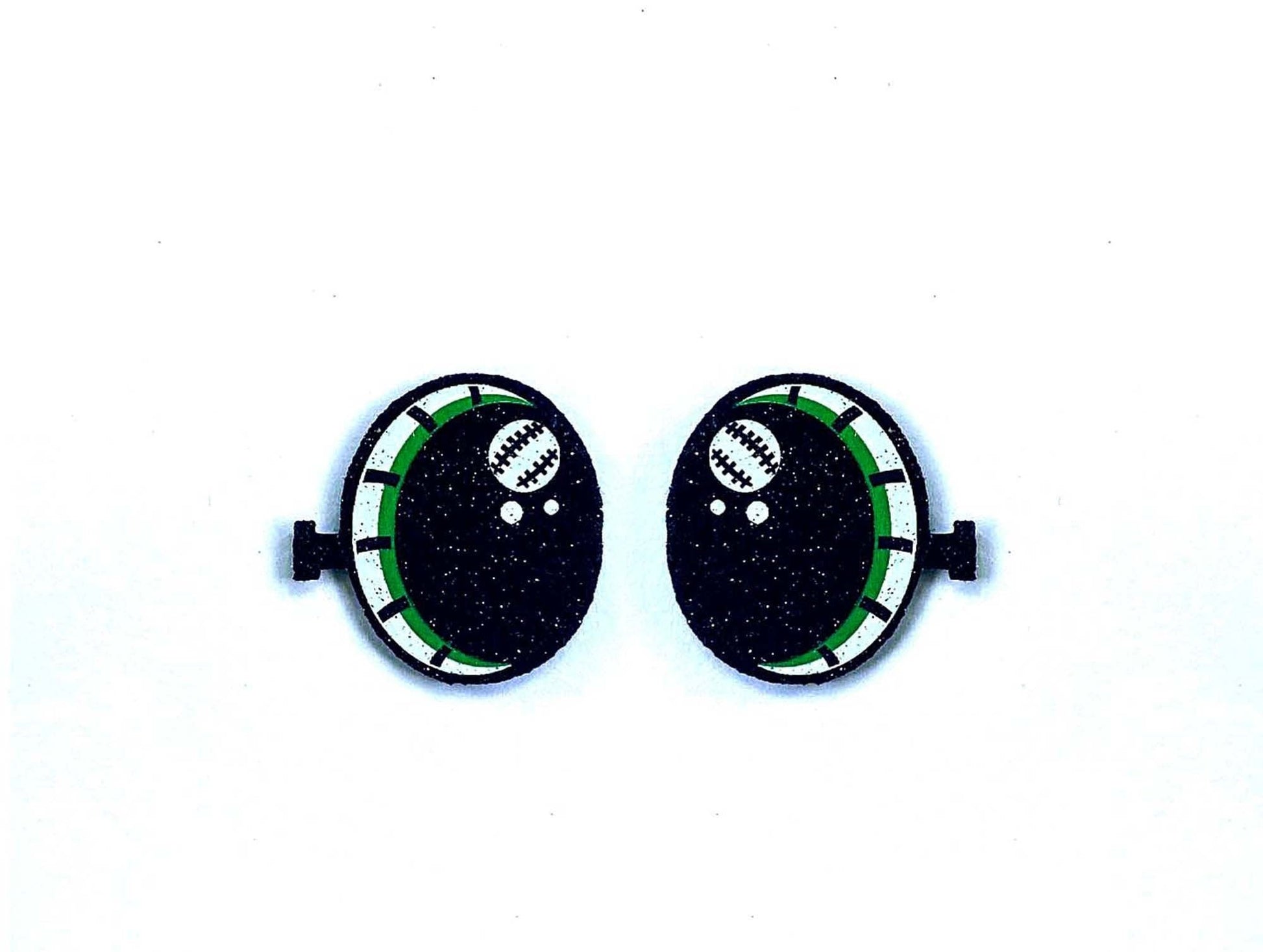 a pair of black and green buttons on a white background