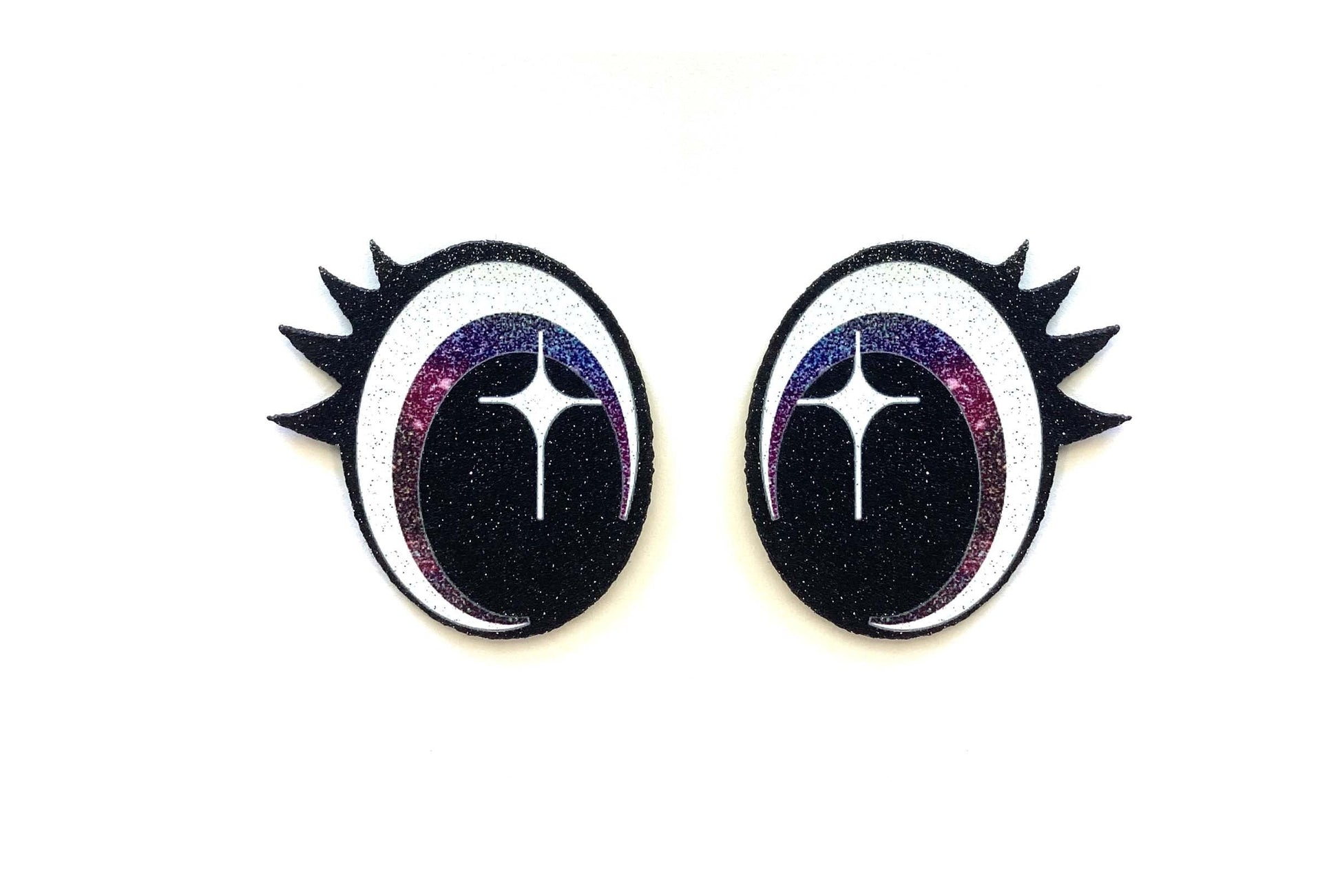 a pair of black and white earrings with spikes
