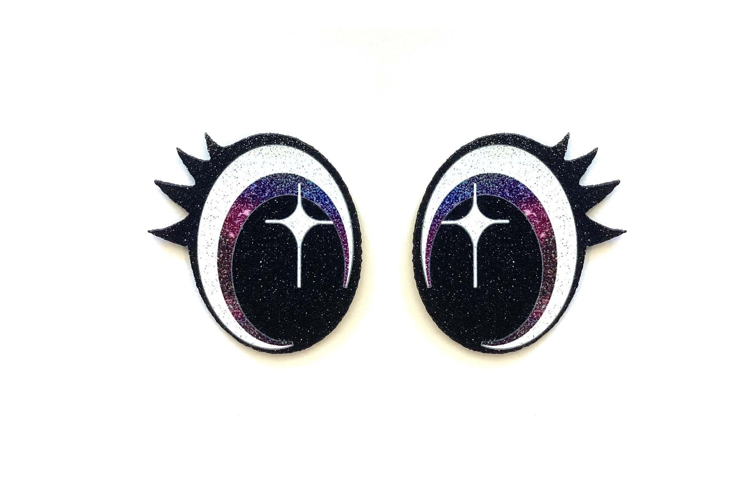 a pair of black and white earrings with spikes