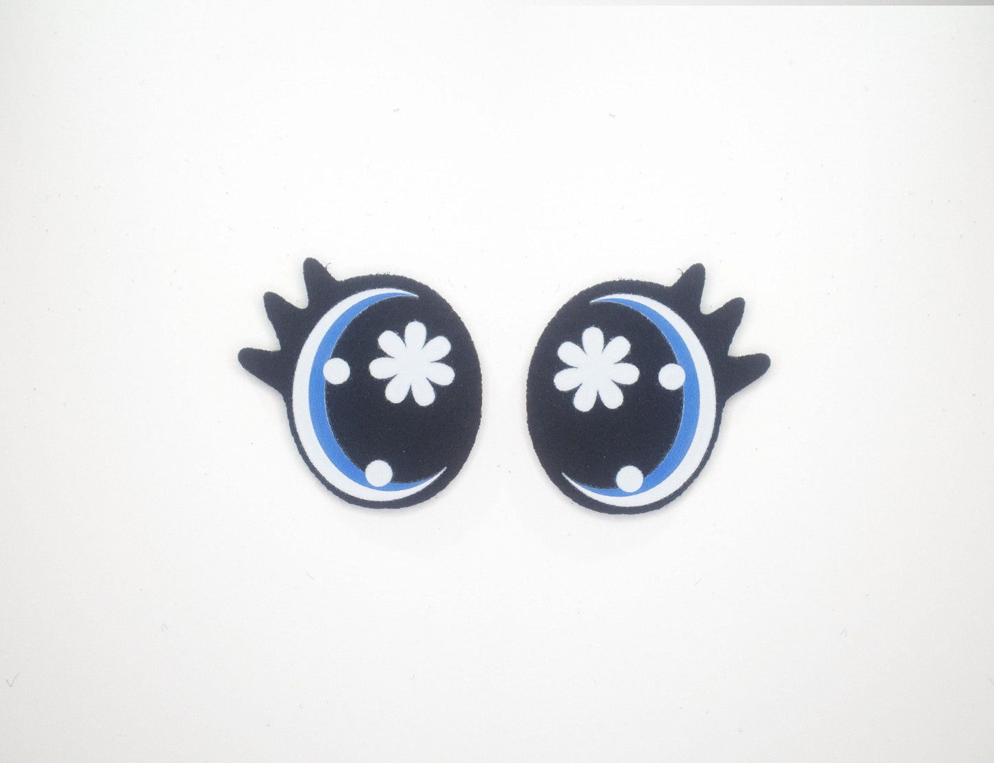 a pair of black and blue earrings on a white background