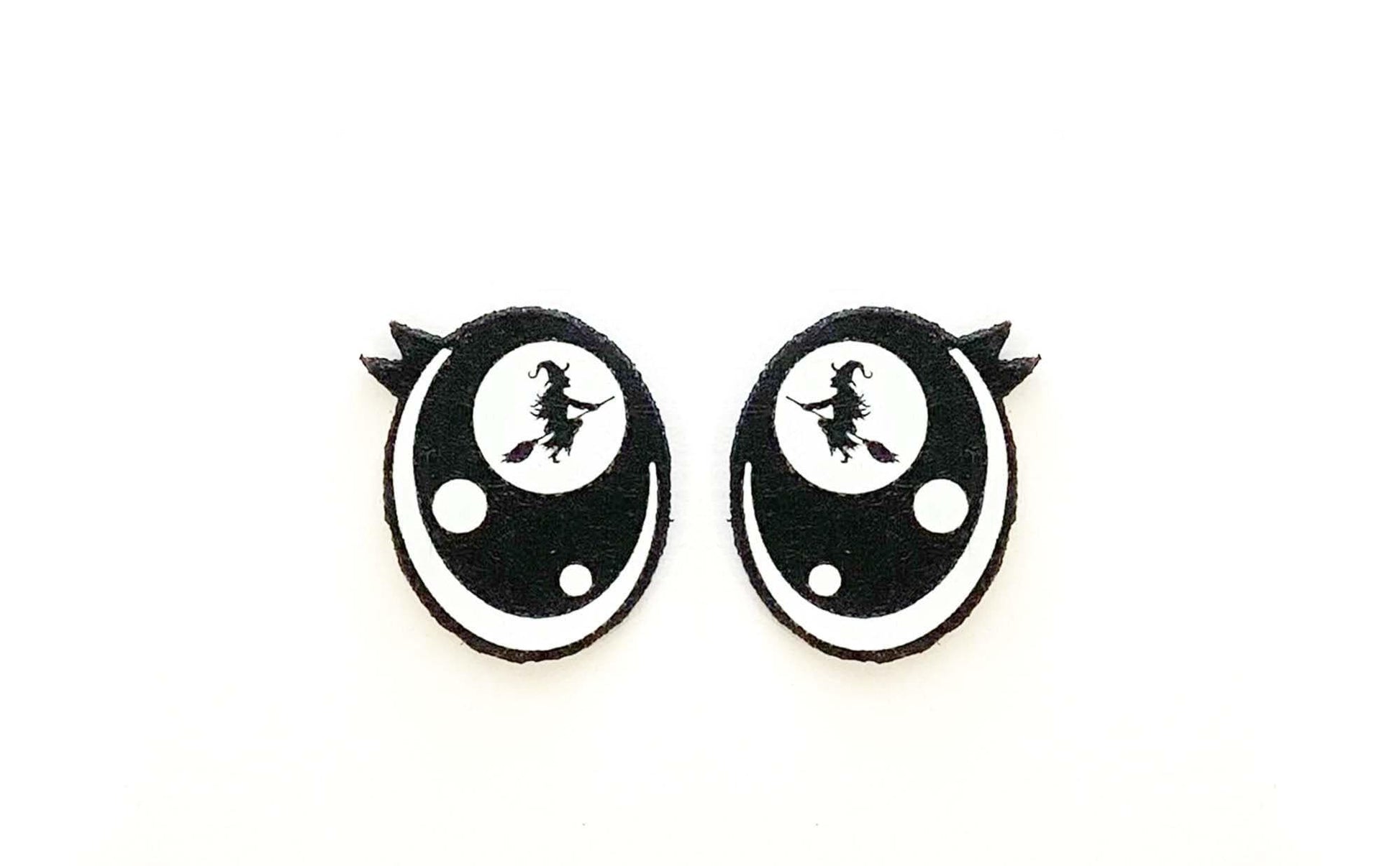 a pair of black and white earrings on a white background