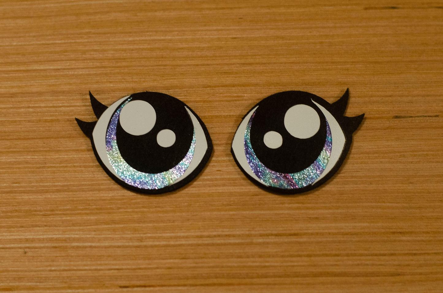 a couple of black and white buttons on a wooden surface