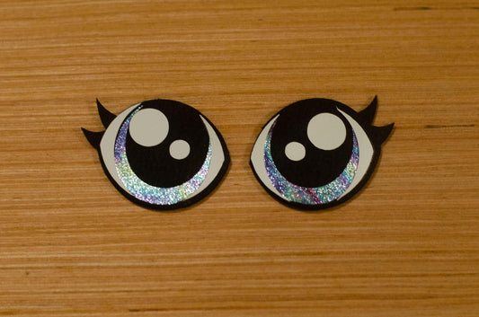 a couple of black and white buttons on a wooden surface