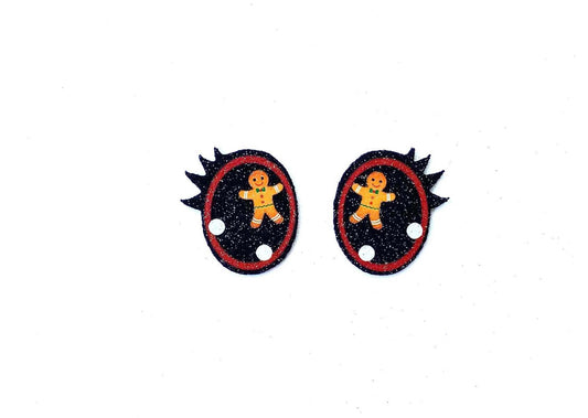 a pair of black and red buttons with a picture of a teddy bear