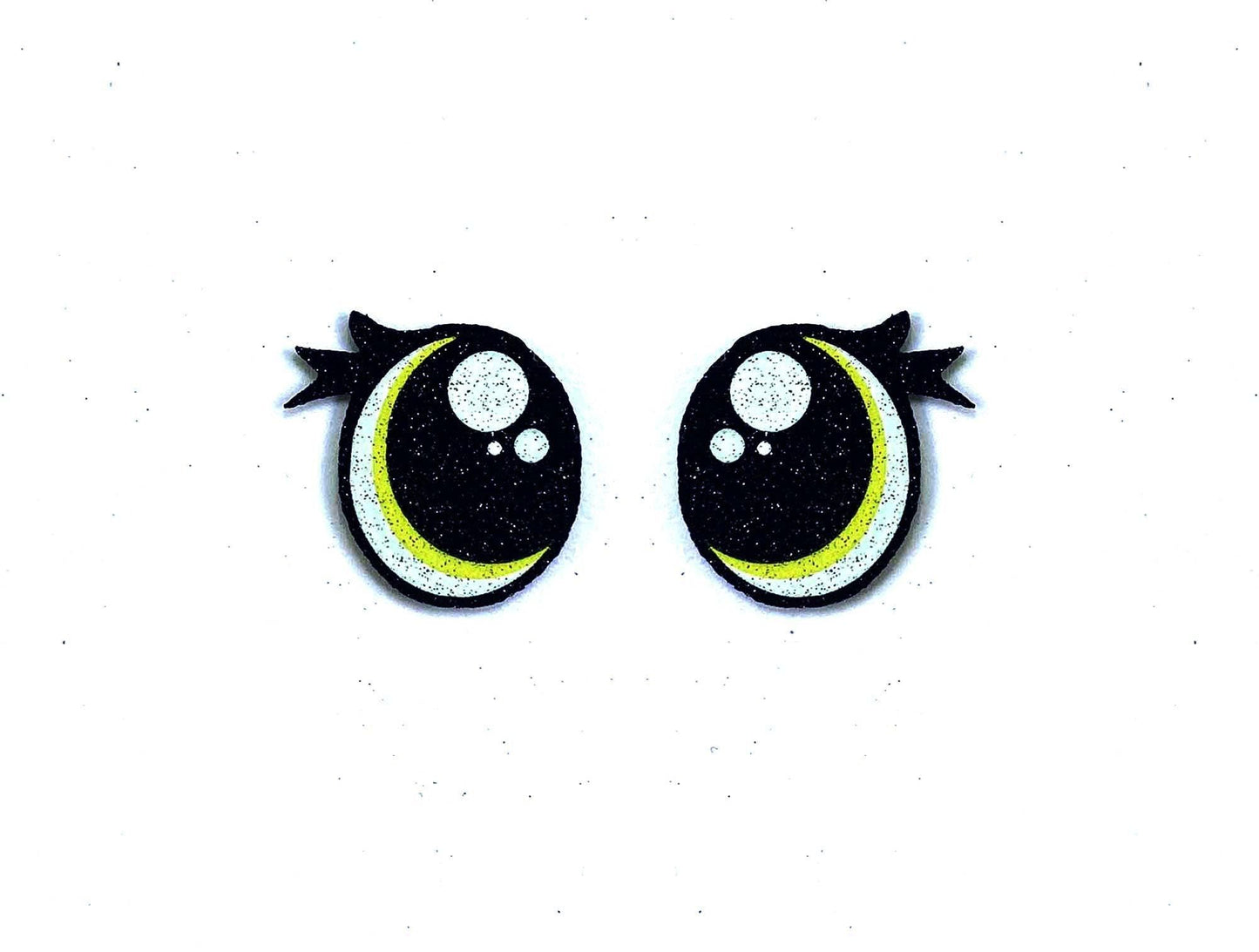 a pair of black and yellow eyes with black bows