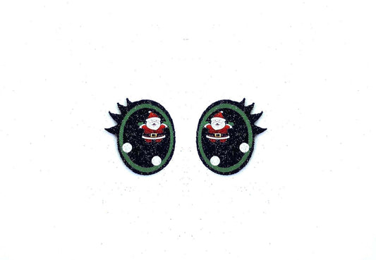a pair of black and green earrings with a santa clause on it