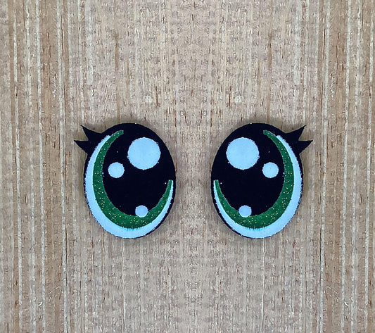 a pair of black and green buttons with white dots
