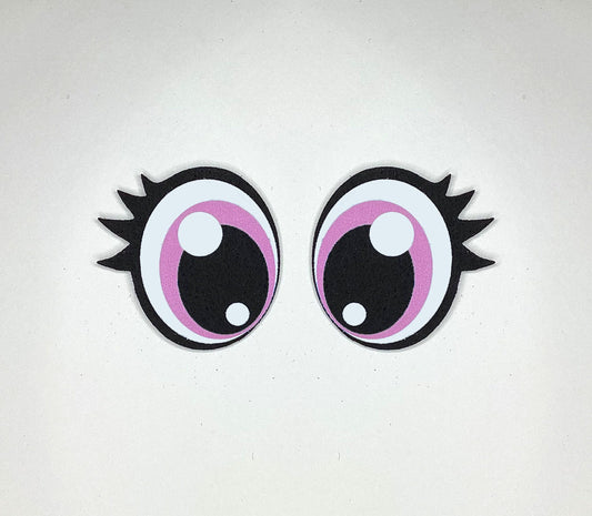 a pair of pink and black eyeballs on a white surface